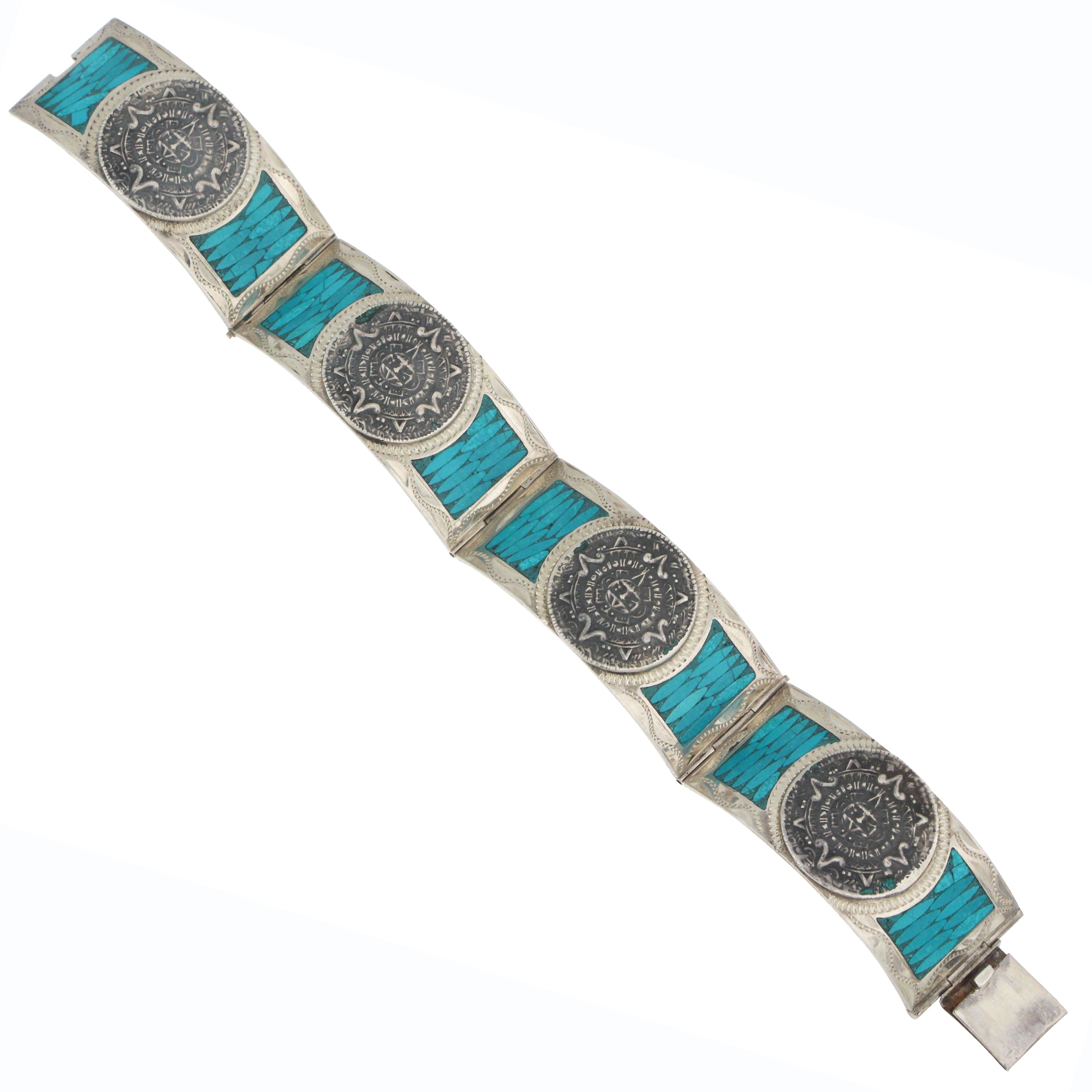 Sterling silver bangle with turquoise inlay panels and engraved medallion design